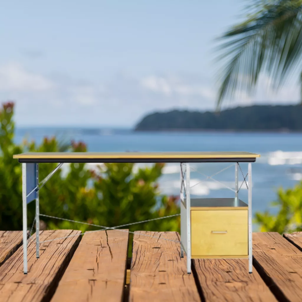 A desk on a deck looking at the ocean.